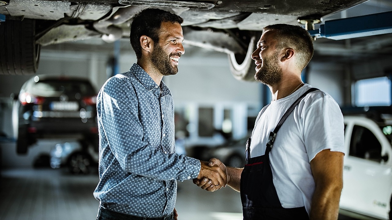 Mechanic shaking hand of a customer
