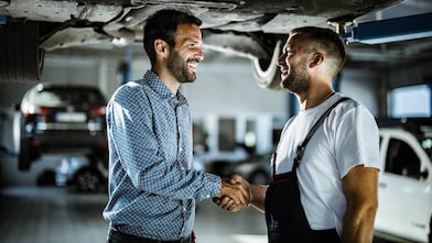 Mechanic shaking hand of a customer