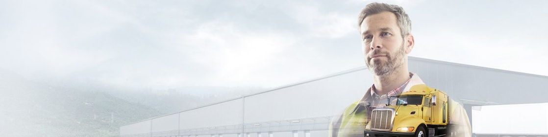 man reading a document transposed onto a background of a site and yellow truck