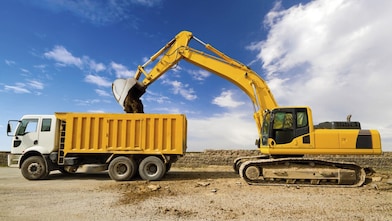 Excavator loading dumper truck