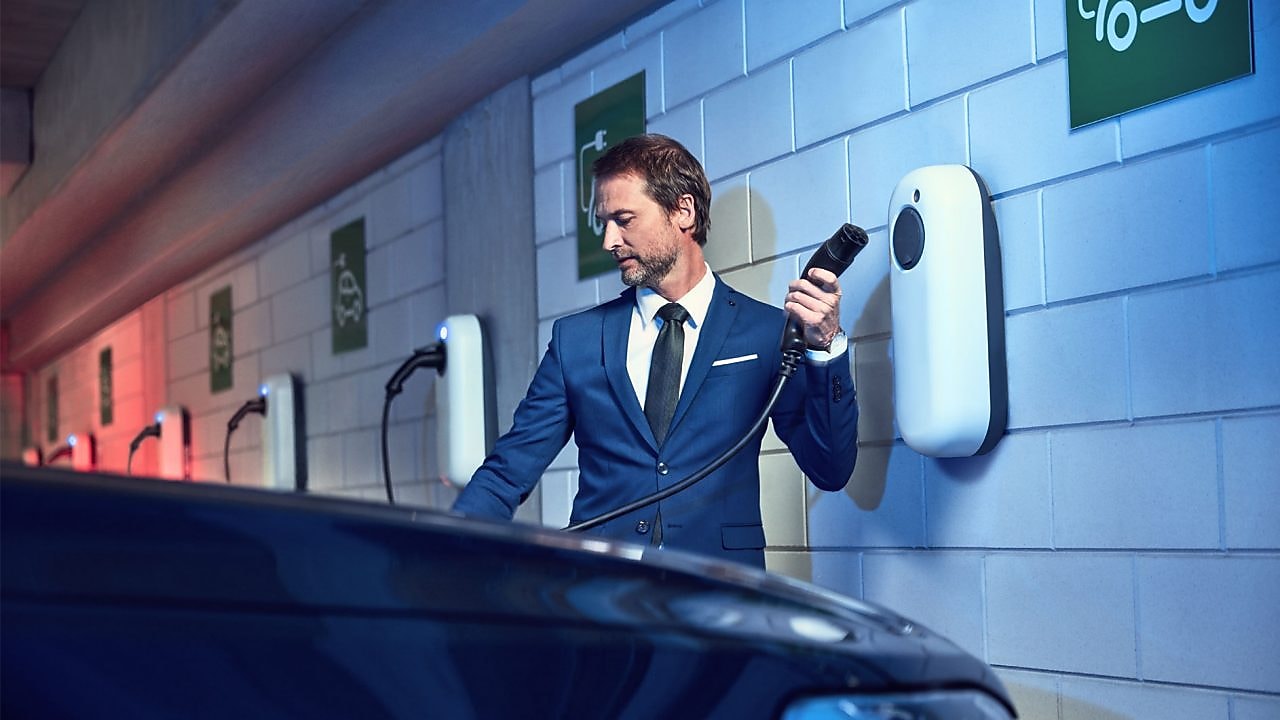 business man recharging is vehicle