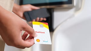 Une personne utilise une carte euroshell dans une machine à carte