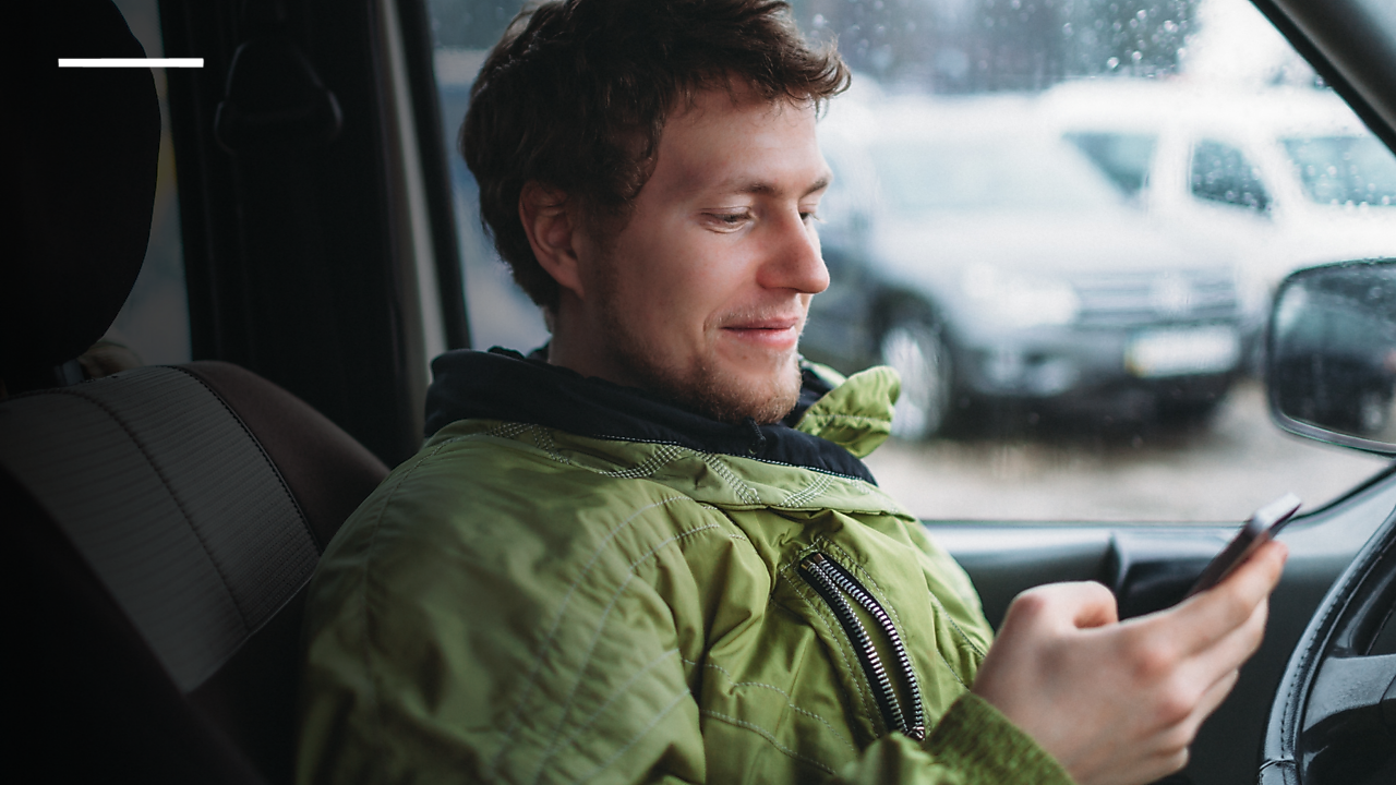 Man using mobile in car
