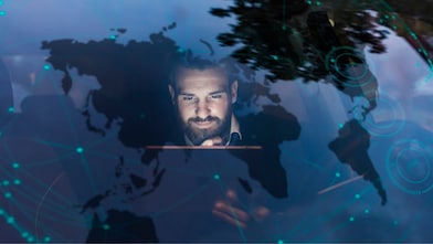 Businessman with tablet in car at night surrounded by data